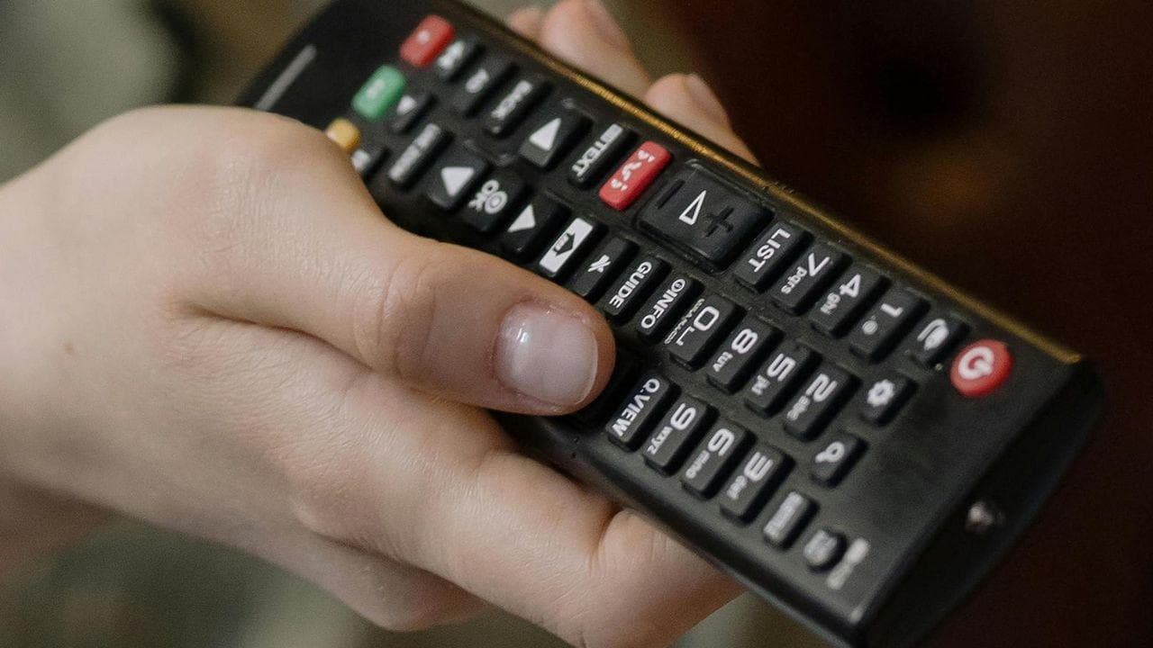 Cambiando canal sujetando mano mando Cambiando canal sujetando mano mando