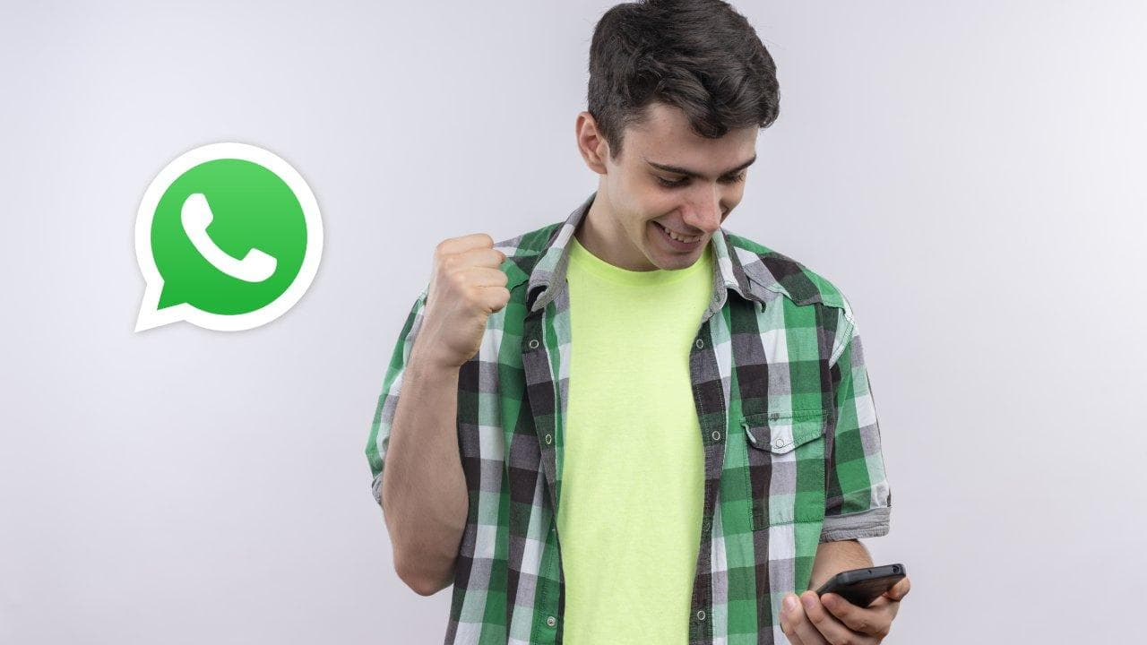 joyful caucasian young man wearing green shirt looking phone his hand showing yes gesture isolated white wall joyful caucasian young man wearing green shirt looking phone his hand showing yes gesture isolated white wall